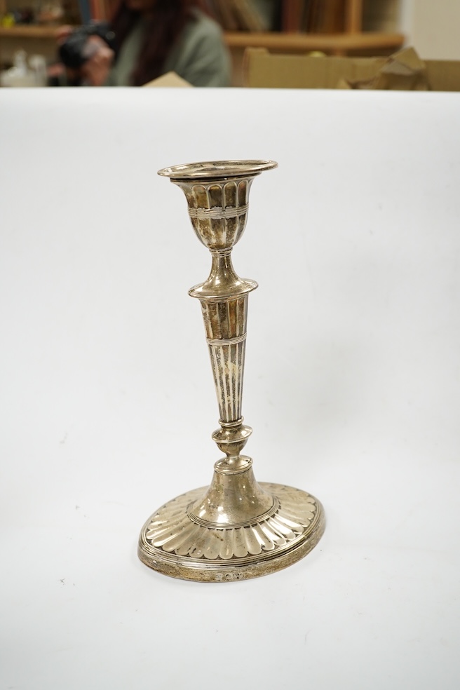 A matched pair of Edwardian silver oval candlesticks, Hawksworth, Eyre & Co and Goldsmiths & Silversmiths Co Ltd, height 21.9cm, weighted. Condition - fair